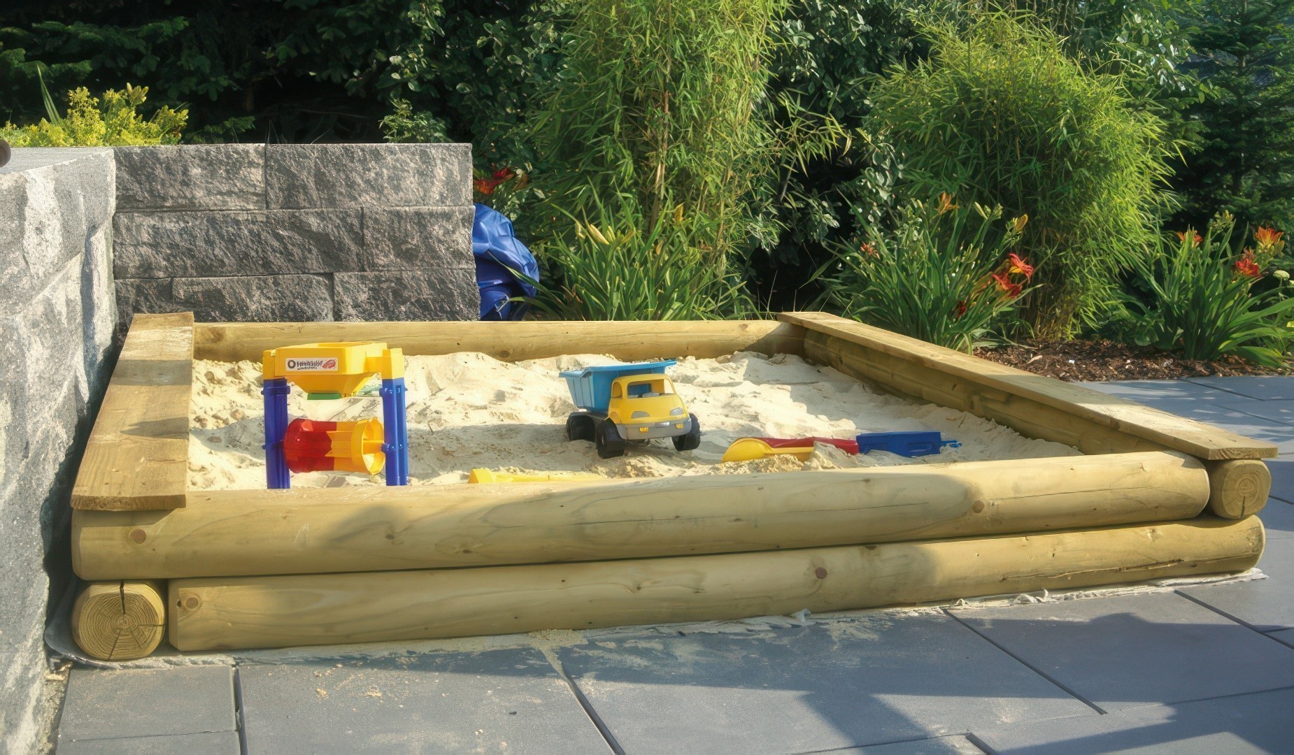 Baumstamm Sandkasten